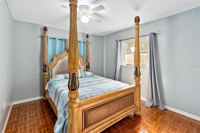 bedroom featuring ceiling fan, dark parquet flooring, and a textured ceiling