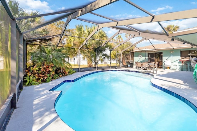 view of swimming pool featuring a lanai and a patio area