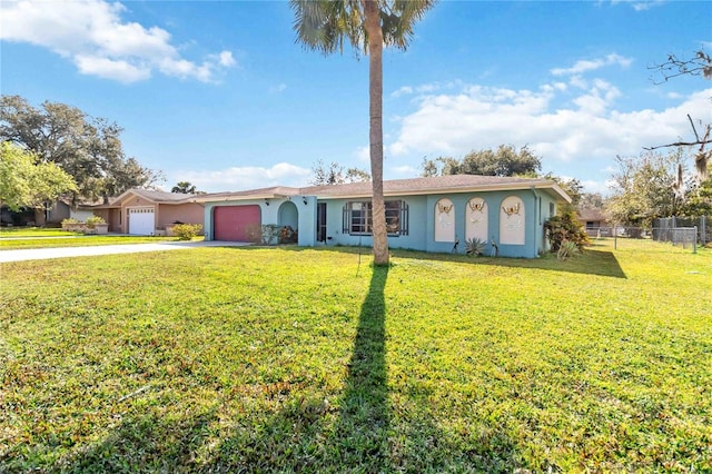 ranch-style home with a garage and a front yard