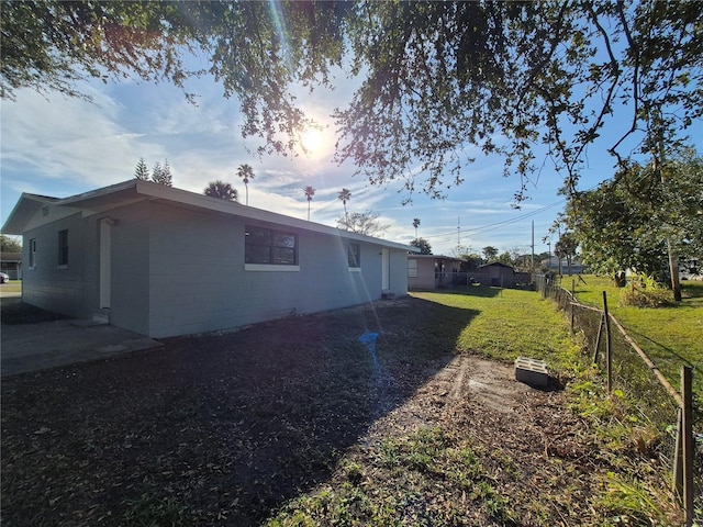 view of side of property with a lawn