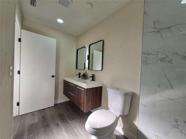 bathroom with vanity, hardwood / wood-style floors, and toilet