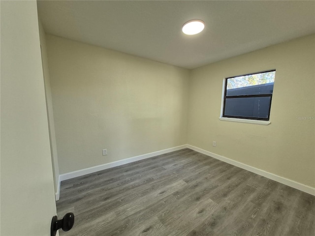 unfurnished room with hardwood / wood-style floors