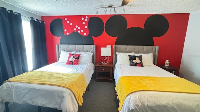 bedroom featuring ceiling fan, carpet floors, and a textured ceiling