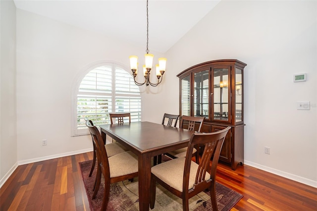 dining area with an inviting chandelier, dark hardwood / wood-style flooring, and vaulted ceiling