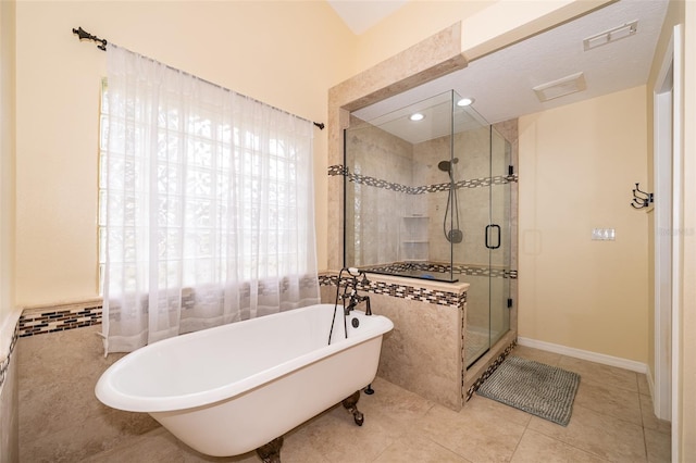 bathroom featuring plus walk in shower, tile walls, and tile patterned floors