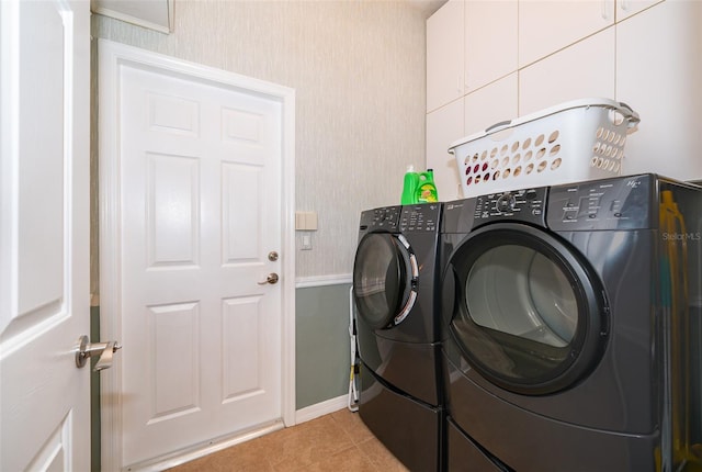 washroom featuring separate washer and dryer and light tile patterned floors