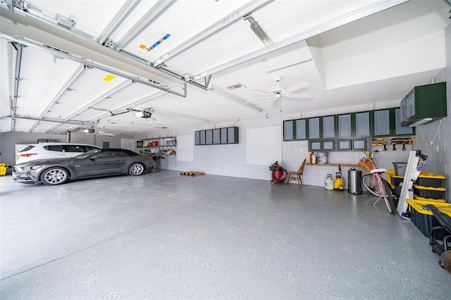 garage featuring a garage door opener and ceiling fan