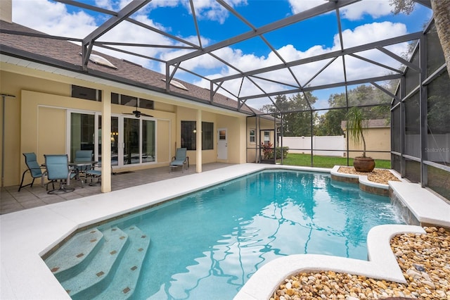 view of pool featuring a lanai, ceiling fan, and a patio area