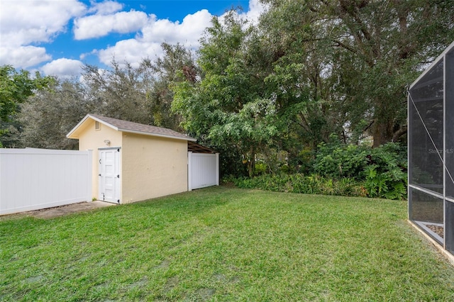 view of yard with a shed and a lanai