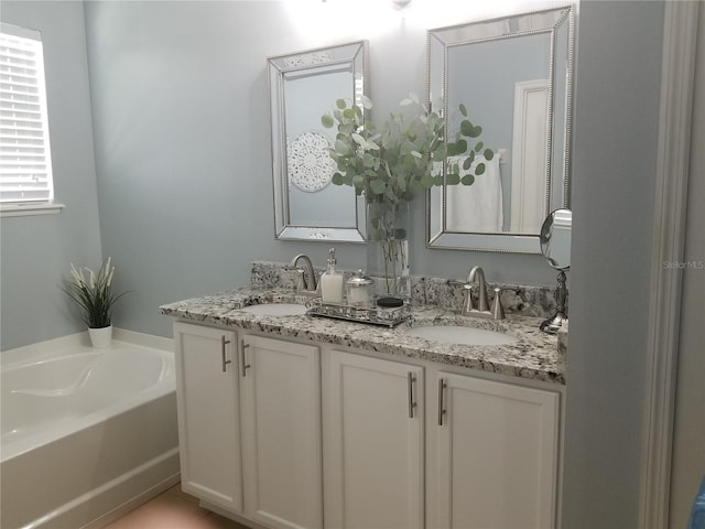 bathroom featuring vanity and a tub