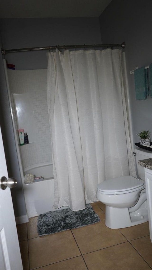 bathroom with toilet and tile patterned flooring