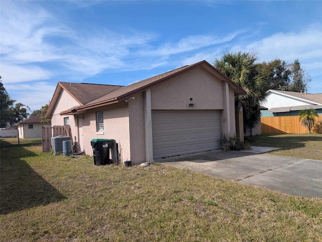 view of property exterior featuring a garage, a lawn, and central air condition unit