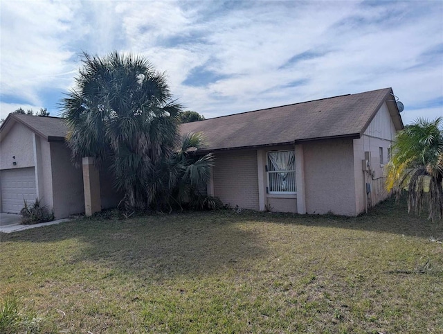 view of side of property with a garage and a yard