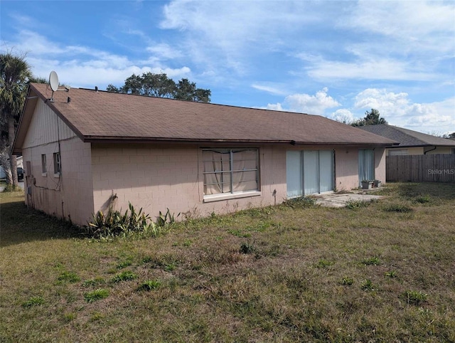 rear view of house featuring a lawn