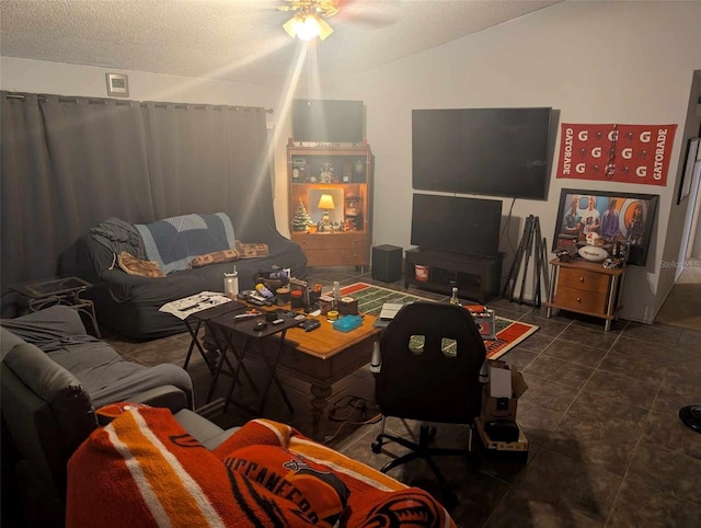 tiled living room featuring lofted ceiling, a textured ceiling, and ceiling fan