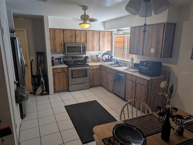 kitchen featuring sink, stainless steel appliances, ceiling fan, and light tile patterned flooring