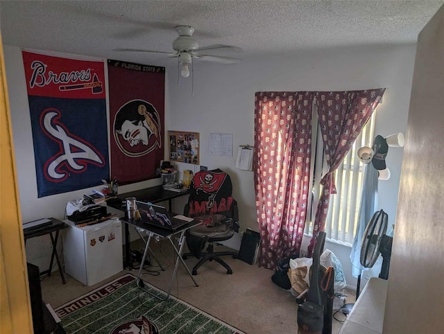 carpeted home office featuring ceiling fan and a textured ceiling