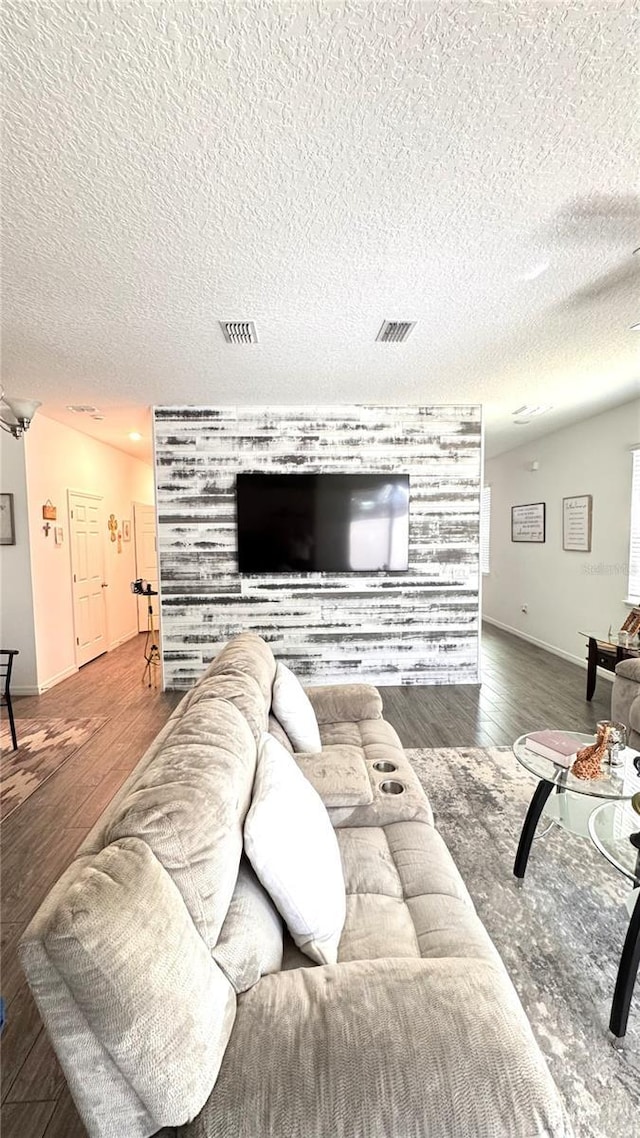 living room with hardwood / wood-style floors and a textured ceiling