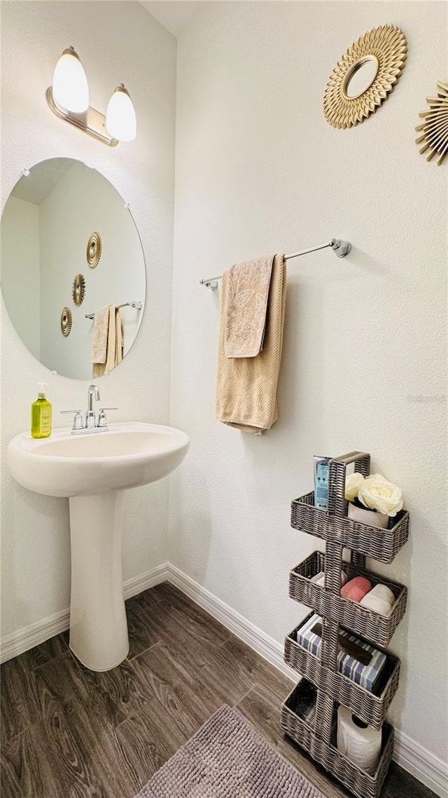 bathroom with hardwood / wood-style flooring and sink