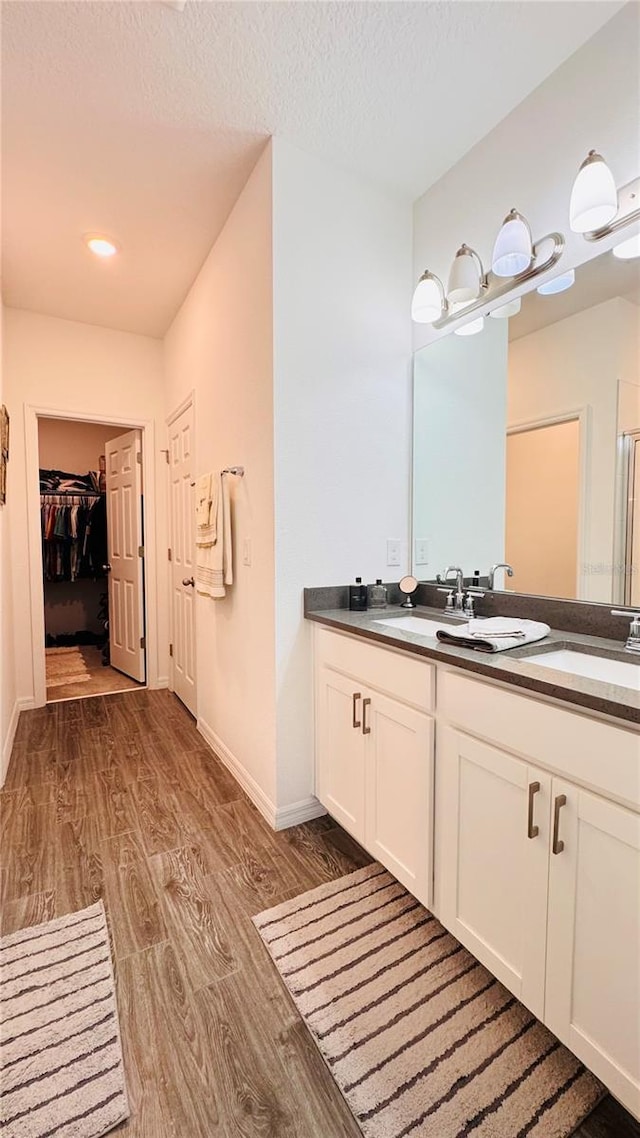 bathroom with vanity, hardwood / wood-style flooring, and a textured ceiling