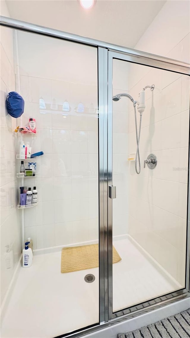 bathroom featuring a shower with door