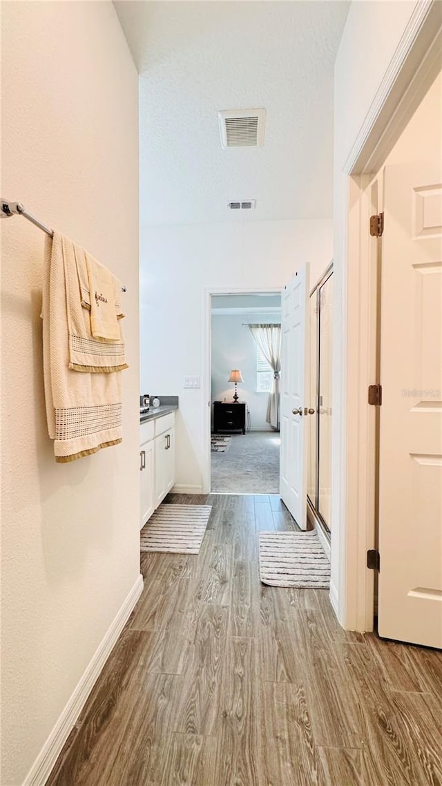 hallway with hardwood / wood-style flooring