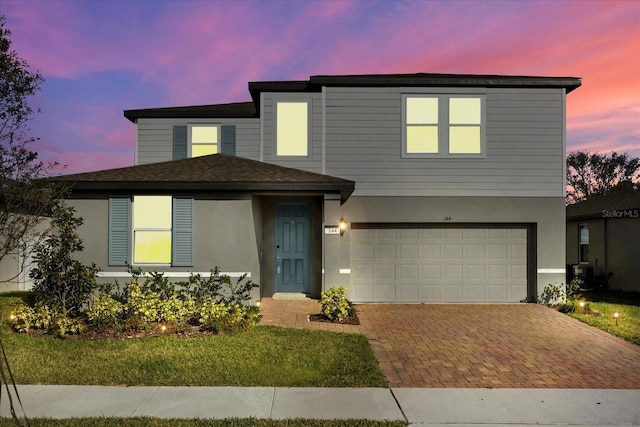 view of front of home featuring a garage and central AC unit