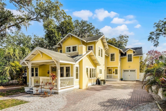 view of front of property featuring a porch and a garage