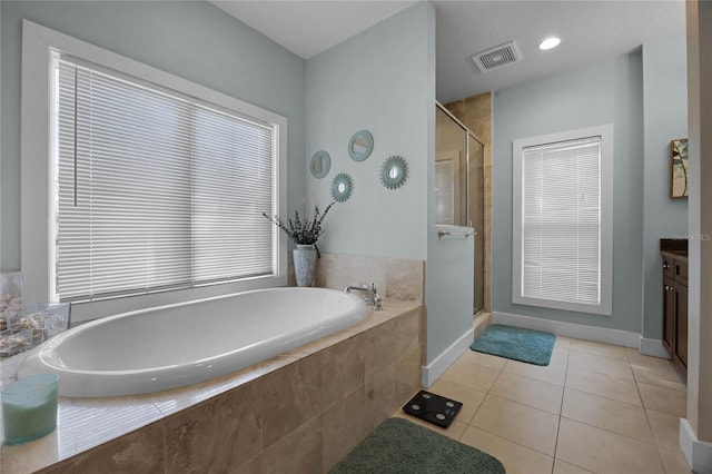 full bathroom featuring visible vents, tile patterned floors, vanity, a shower stall, and a bath