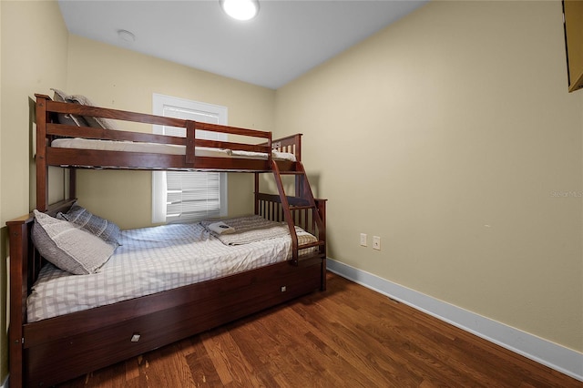 bedroom featuring wood finished floors and baseboards