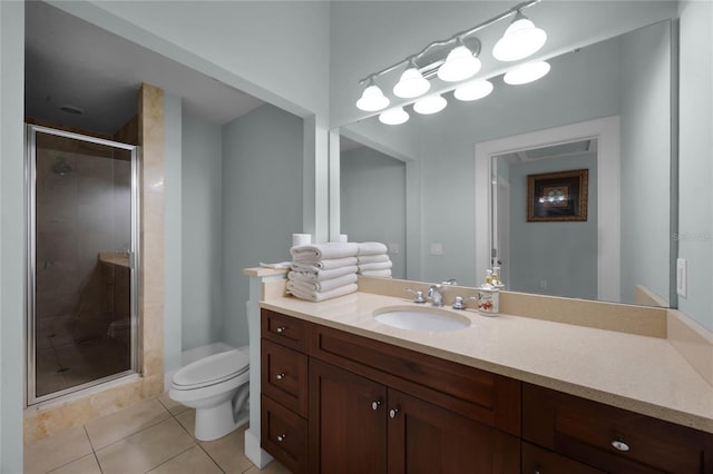 bathroom featuring toilet, tile patterned flooring, a shower stall, and vanity