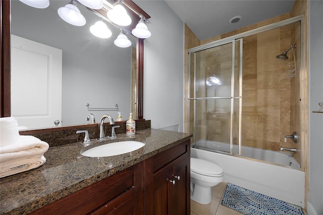 bathroom with enclosed tub / shower combo, vanity, tile patterned flooring, and toilet