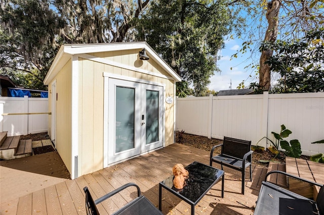 view of outbuilding with a fenced backyard and an outdoor structure