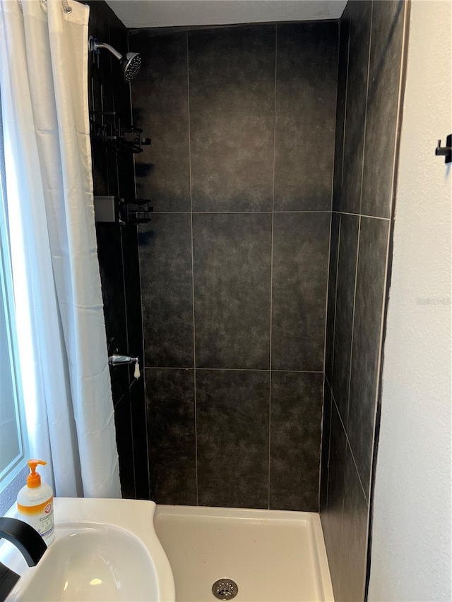 full bath featuring a shower stall and a sink