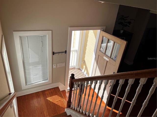 stairway featuring baseboards and wood finished floors