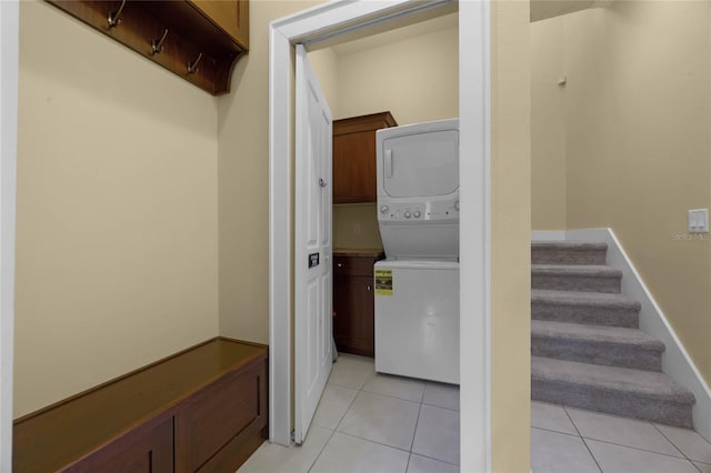 interior space featuring stacked washer and dryer and light tile patterned flooring