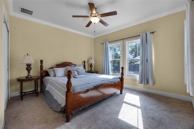 bedroom with light colored carpet, visible vents, crown molding, and baseboards