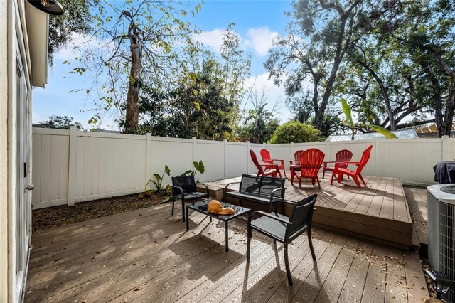 wooden terrace with a fenced backyard and central AC