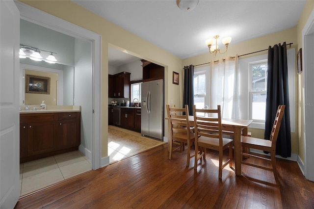 dining space featuring a chandelier and wood finished floors