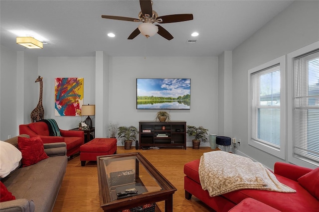 living room with ceiling fan, wood finished floors, visible vents, and recessed lighting