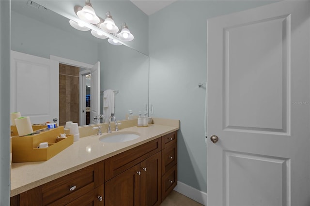 bathroom with visible vents, vanity, and baseboards