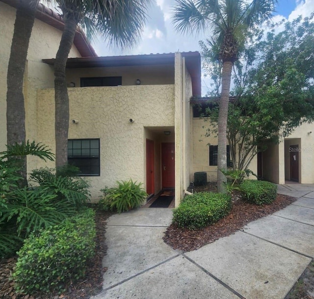 entrance to property featuring cooling unit