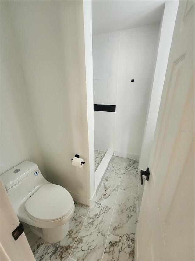 bathroom with walk in shower and toilet