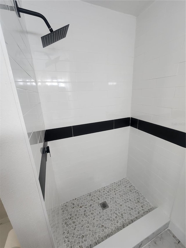 bathroom with tiled shower