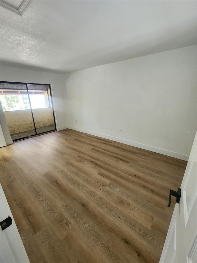 empty room with wood-type flooring