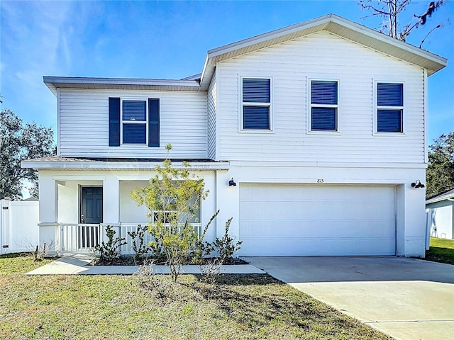 view of front of home with a garage, a front lawn, and covered porch