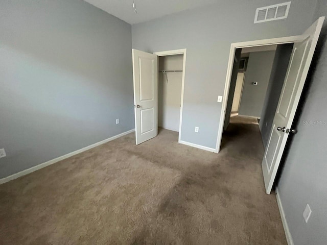 unfurnished bedroom featuring carpet and a closet