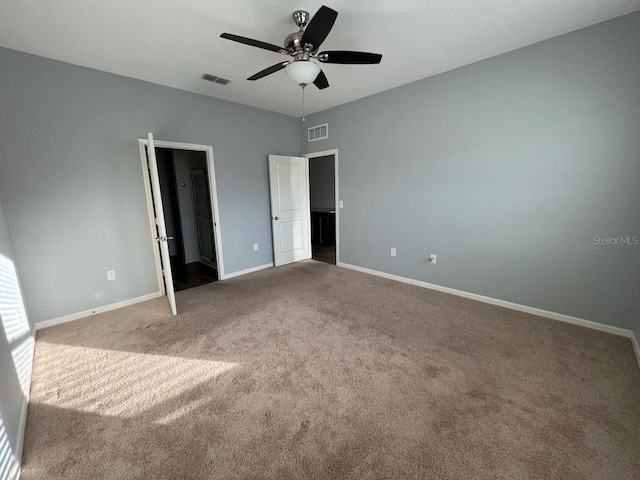 unfurnished bedroom with ceiling fan and carpet floors