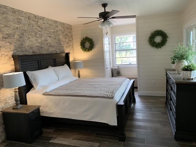 bedroom with ceiling fan and dark hardwood / wood-style flooring