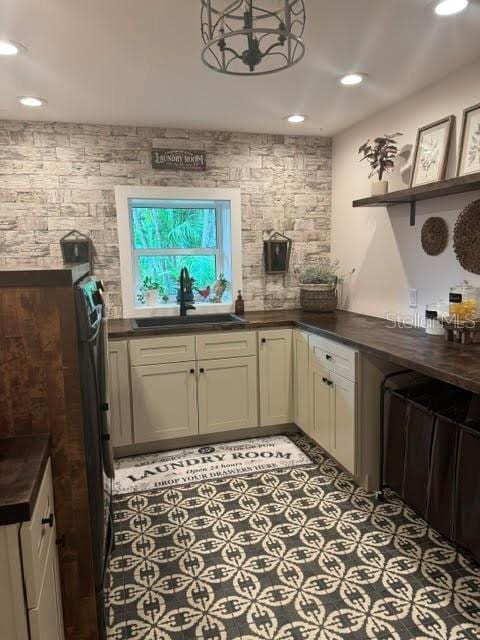 kitchen featuring cream cabinets and sink